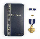 Navy Cross presentation box with ribbon bar, lapel pin and Navy Cross medal arranged vertically…
