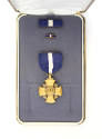 Navy Cross, lapel pin and ribbon bar placed in open presentation box