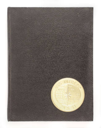 Black cover of USS Intrepid cruise book with gold circular Intrepid insignia in lower right cor…