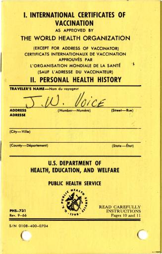 Cover of yellow International Certificates of Vaccination booklet with printed lettering throug…