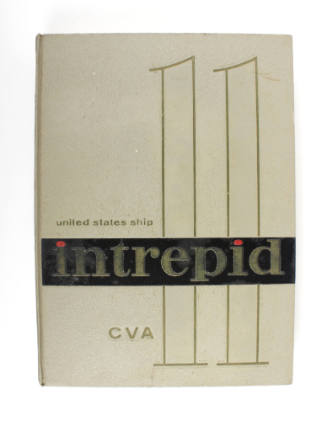 Cream hardcover 1960–1961 USS Intrepid cruise book with a large "11"