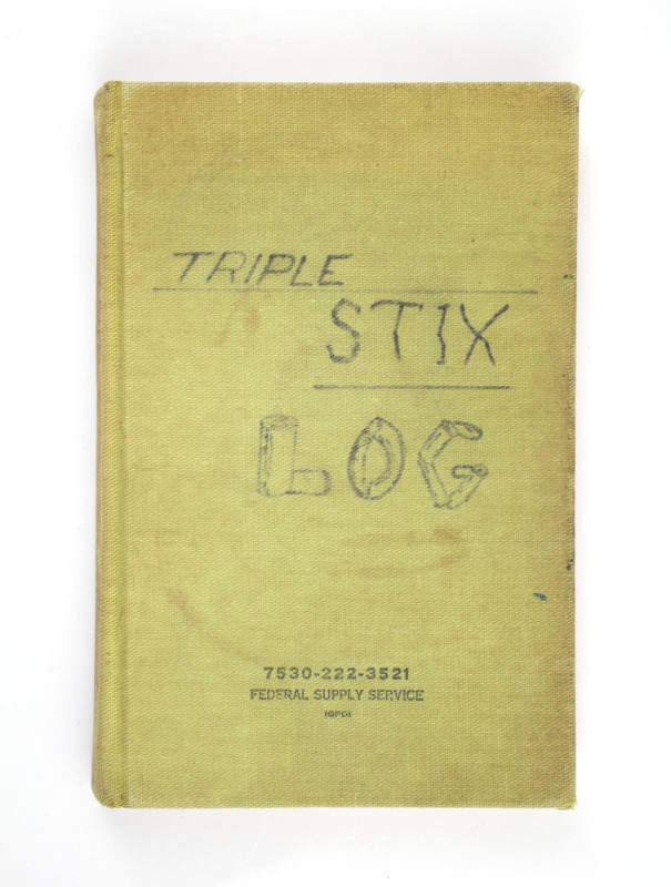 Green hardcover book with handwritten title "Triple Stix Log"