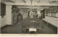 Black and white commercial Japanese postcard showing a room with a long table