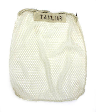 Mesh laundry bag with "Taylor" written in block letters on tab near zipper