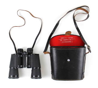 Binoculars with attached strap alongside their black carrying case