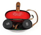 Binoculars inside their case, which is open to show red felt interior with adhered labels “Samu…