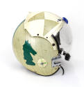 Side view of helmet with clear visor, green rook chess piece shaped image on off-white  reflect…