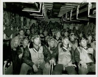 Black and white photograph of pilots seated in the ready room
