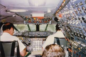 Color image of the cockpit of a British Airways Concorde airplane with members of the flight cr…