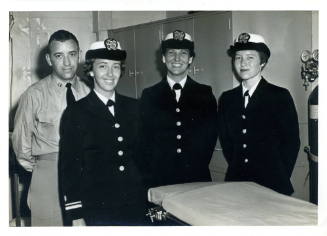 Printed black and white photograph of three U.S. Navy nurses and one medical officer in USS Int…