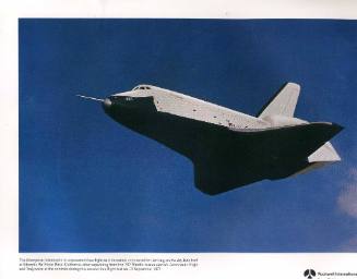 Color photograph of Enterprise in free-flight against a blue sky