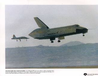 Color photograph of Enterprise with chase plane making first free-flight landing