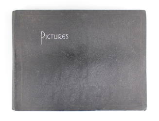 Black cover of photo album with the word "Pictures" in white text at the upper left corner