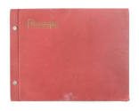 Cover of red scrapbook that has “Photographs” embossed on the top left corner