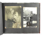 Scrapbook page with two black and white photographs, one of two service men and a camera and th…