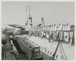 Black and white photograph of the crew lined up on deck of USS Growler at the commissioning cer…