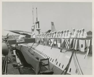 Black and white photograph of the crew lined up on deck of USS Growler at the commissioning cer…
