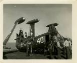 Black and white photograph of a damaged Piasecki HUP-2 Retriever helicopter on USS Intrepid's f…