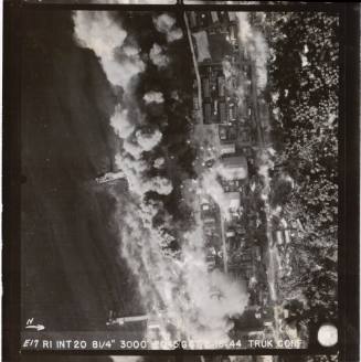 Black and white aerial photograph of military facilities on Truk Atoll after being bombed