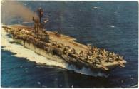 Color postcard of the aircraft carrier USS Intrepid at sea, with airplanes on the flight deck