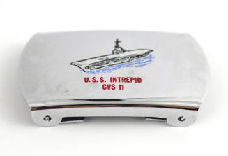 Silver belt buckle with colored enamel image of USS Intrepid at sea, red inscription "U.S.S. In…