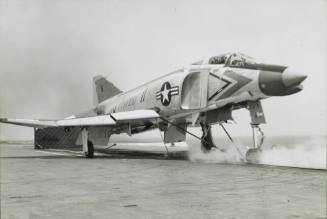 Black and white photograph of a McDonnell Douglas F-4 Phantom II on a steam catapult