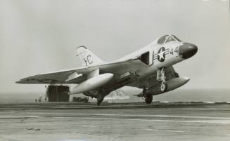 Black and white photograph of a Douglas F4D-1 Skyray landing on the flight deck