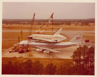 Color photograph of space shuttle Enterprise being removed from airplane