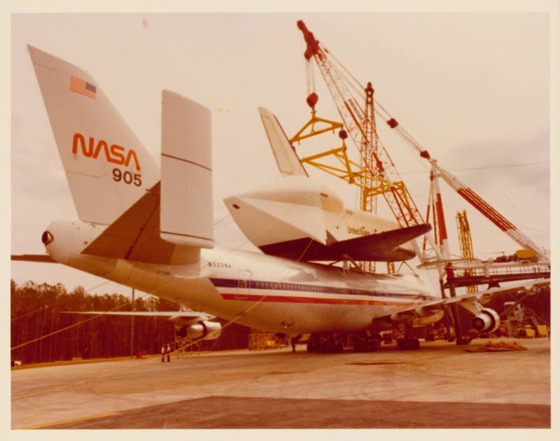 Color photograph of space shuttle Enterprise on top of a plane