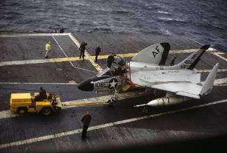 Color photograph of F4D Skyray being towed on Intrepid's flight deck