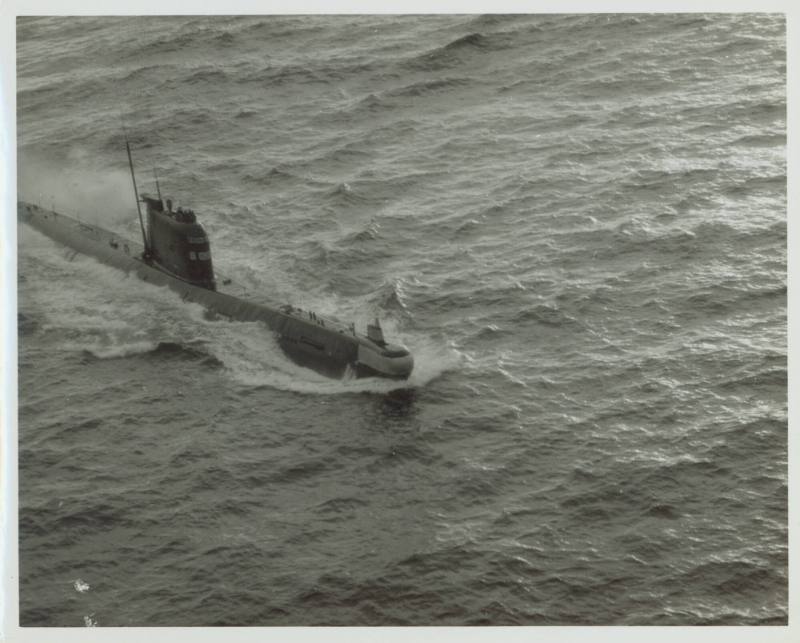 Black and white photograph of a Russian submarine breaking the surface of the water