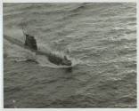 Black and white photograph of a Russian submarine breaking the surface of the water