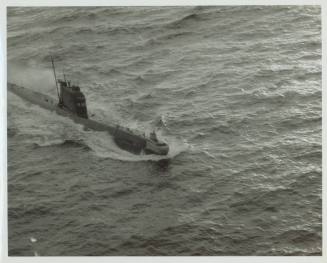 Black and white photograph of a Russian submarine breaking the surface of the water