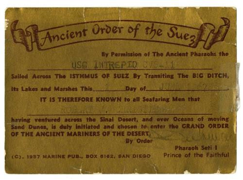 Gold membership card for Ancient Order of the Suez with black lettering and written inscription