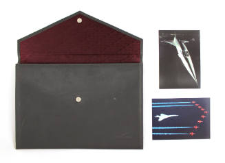 Gray leather stationery envelope with two color postcards to the right with image of Concorde a…
