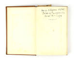 Inside cover of book open to show handwritten inscription “Harry A Repass ARM2/c Bombing Squadr…