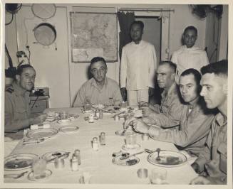 Black and white photograph of Admiral Thomas Sprague at wardroom table with other officers and …