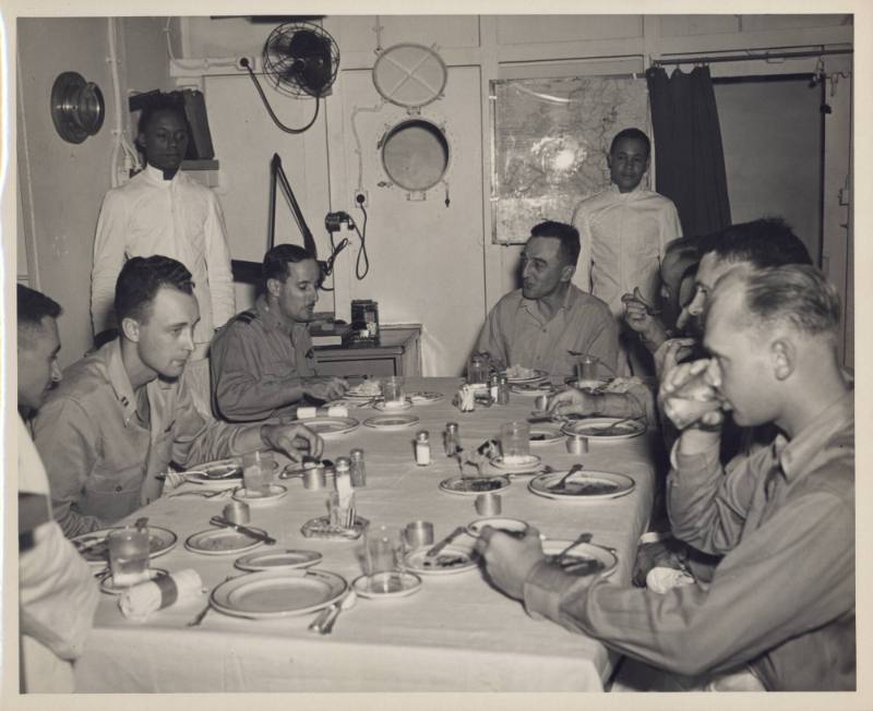 Black and white photograph of Admiral Thomas Sprague at a wardroom table dining with other offi…