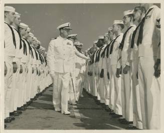 Black and white photograph of USS Intrepid’s commanding officer, Capt. William Easton, inspecti…
