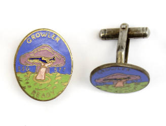 Pair of cufflinks with second USS Growler insignia depicting a hand reaching out of green water…