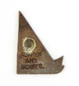 Rear face of sailboat pin with screw on backing and engraved inscription