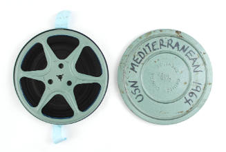 8mm film and metal cannister that reads "USN Mediterranean 1964"