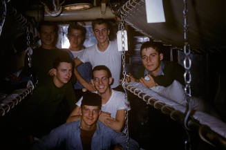 Digital color image of sailors in a berthing area smiling at the camera