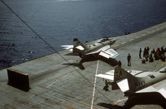 Digital color image of a Grumman F9F-6 Cougar on the port side steam catapult