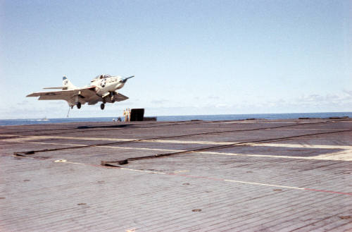 Digital color image of a Grumman F9F Cougar about to land on Intrepid's flight deck