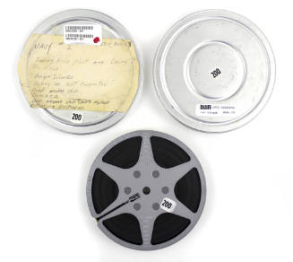 Film reel and metal cannister with a label that reads in part “May 63 – Dec 63”