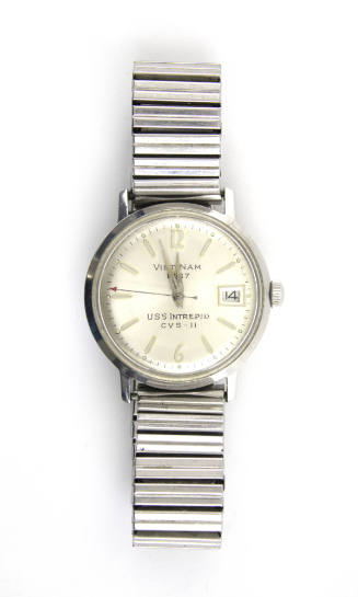 Silver wristwatch with "Vietnam 1967" and "USS Intrepid" printed on its circular face