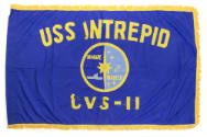 Royal blue flag with fringe on three sides, circular USS Intrepid insignia in center surrounded…