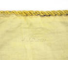 Close up view of faded black stamp “J.J. Durrett” on bottom edge of yellow pillowcase fabric