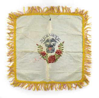 White silk fringed pillowcase with U.S. Navy officer crest in center, imagery of eagle atop fed…